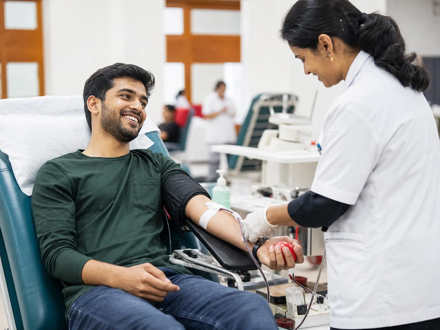 A donor receiving attentive care at a community blood donation camp